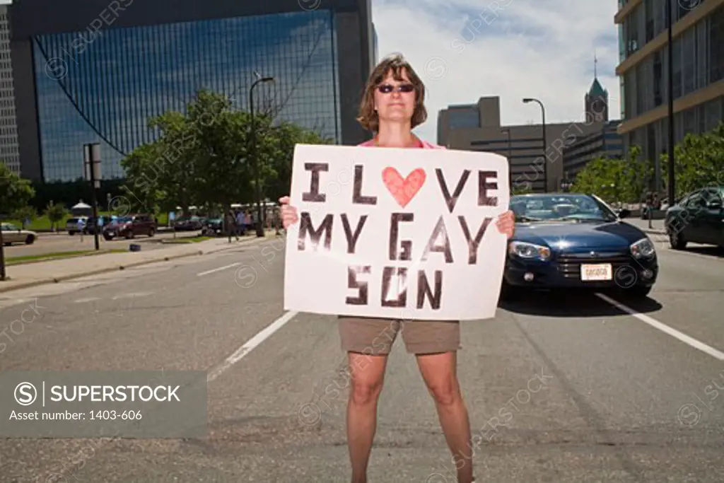 Woman holding a placard in a gay pride parade, Minneapolis, Minnesota, USA