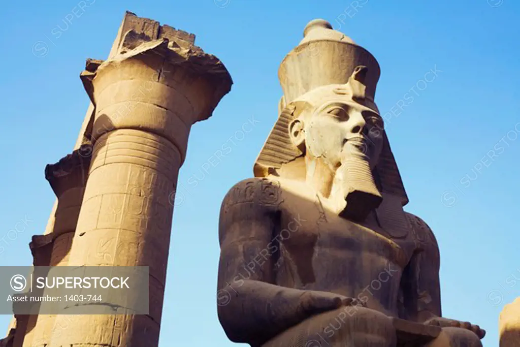 Egypt, Luxor, Temple of Luxor, Colossal seated statue of Ramses II and colonnade of Amenhotep III