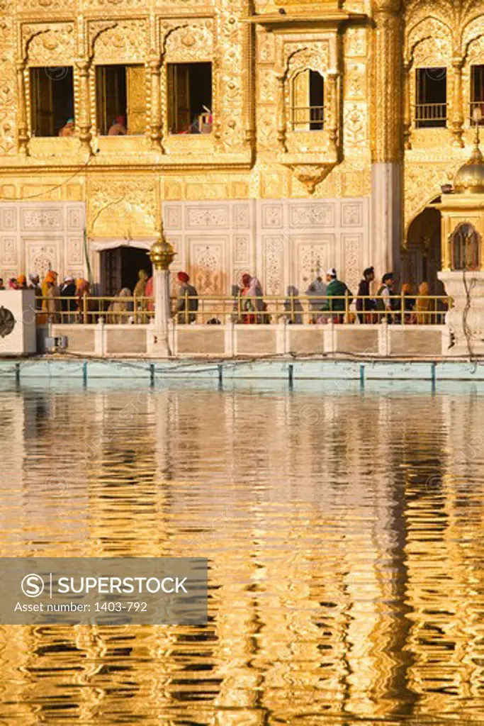 India, Punjab, Amritsar,  Golden Temple reflecting  in waters of  sacred lake