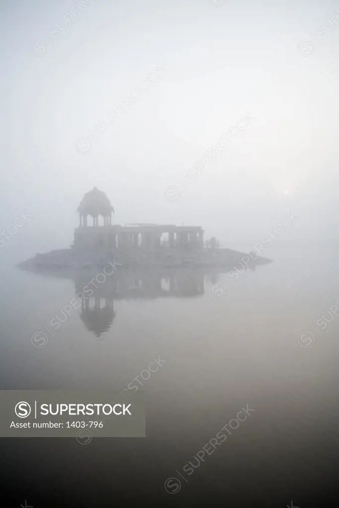 India, Rajasthan, Jaisalmer, Gadisar Temple at Gadisar Lake in fog