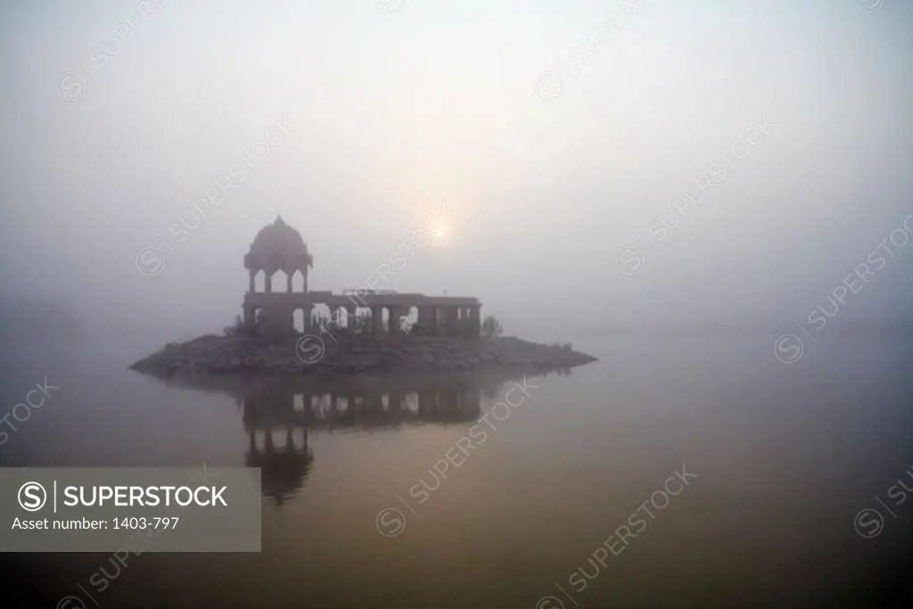 India, Rajasthan, Jaisalmer, Gadisar Temple at Gadisar Lake in fog