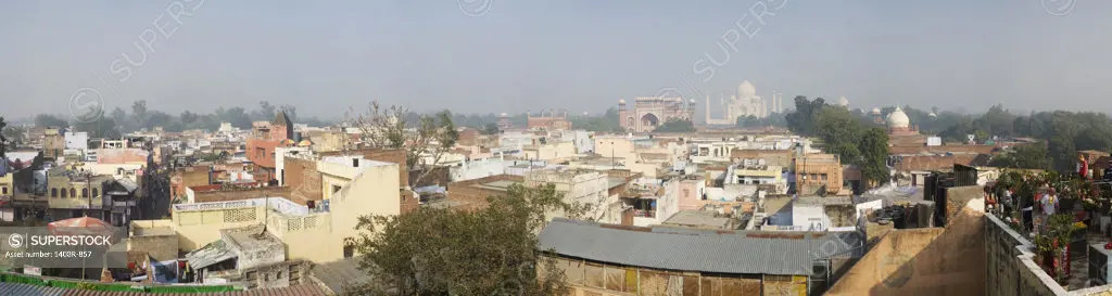 India, Agra, Panoramic view of chaos of guest houses, hotels and roof top restaurants of backpacker's enclave of Taj Ganj below South Gate of Taj Mahal