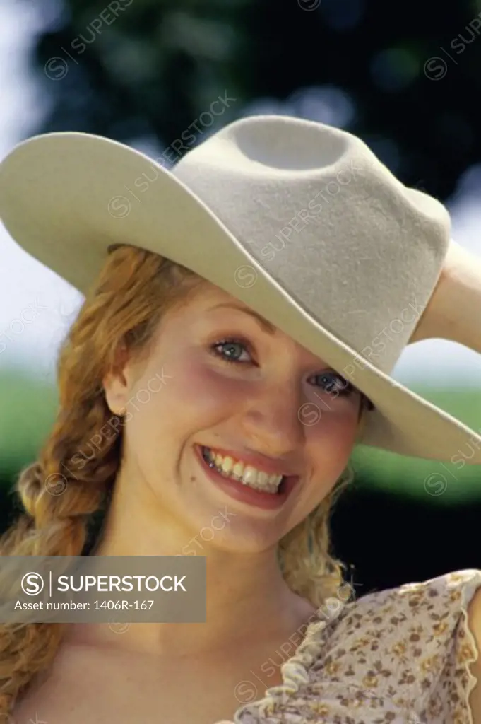 Portrait of a young woman wearing a hat smiling