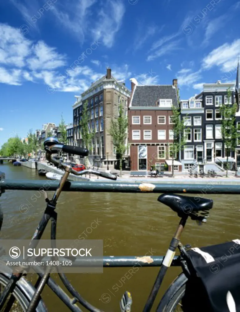 Bicycle parked against a railing, Herengracht Canal, Amsterdam, Netherlands