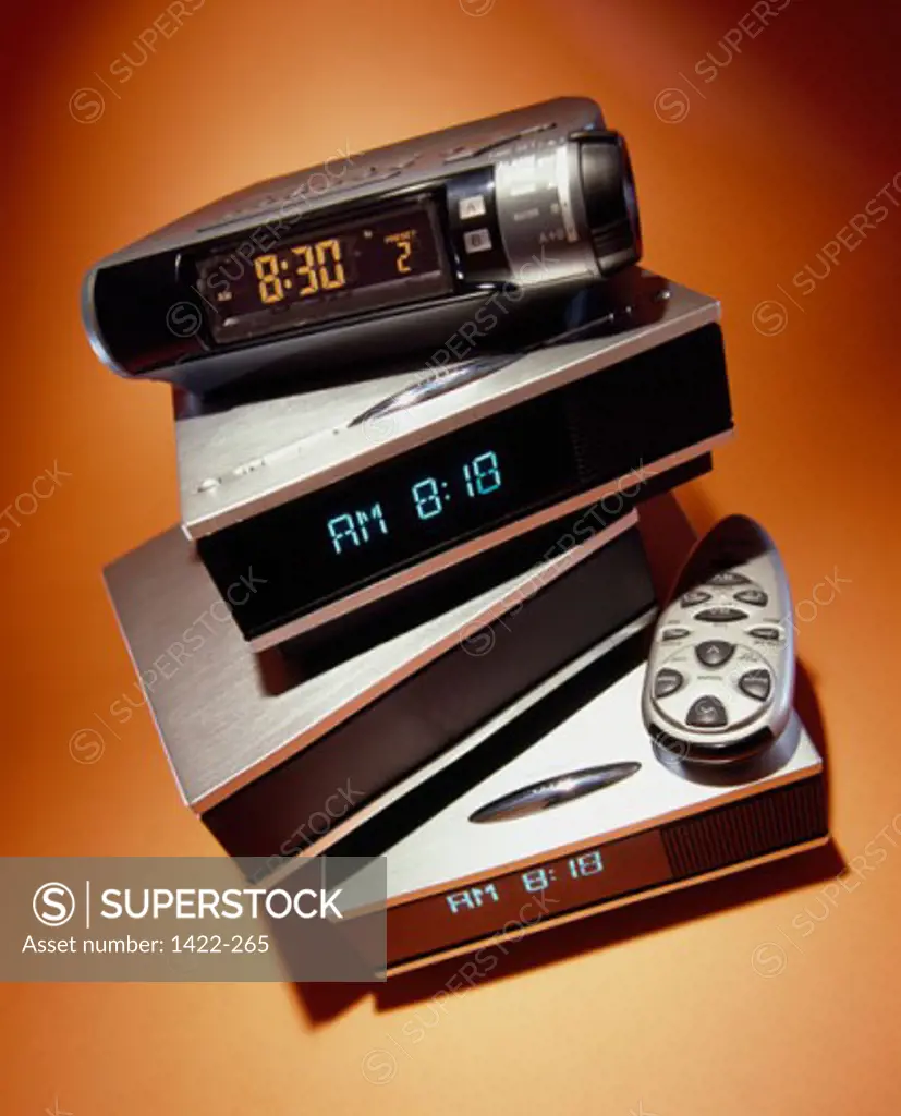 Close-up of a stack of digital clocks with remote control