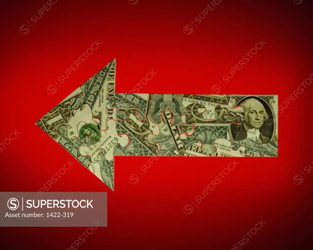 Close-up of an US dollar bill in the shape of an arrow