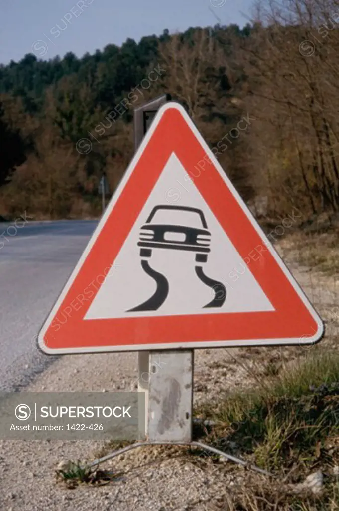 Close-up of a slippery road sign at the roadside