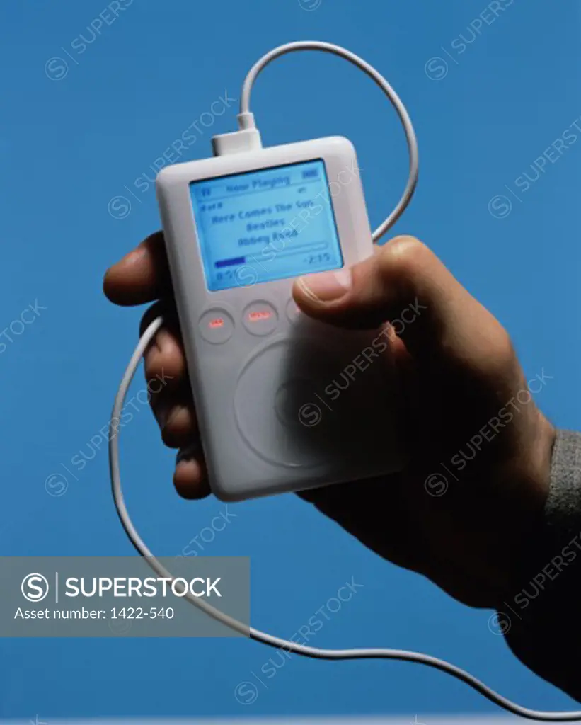 Close-up of a person's hand holding an MP3 Player