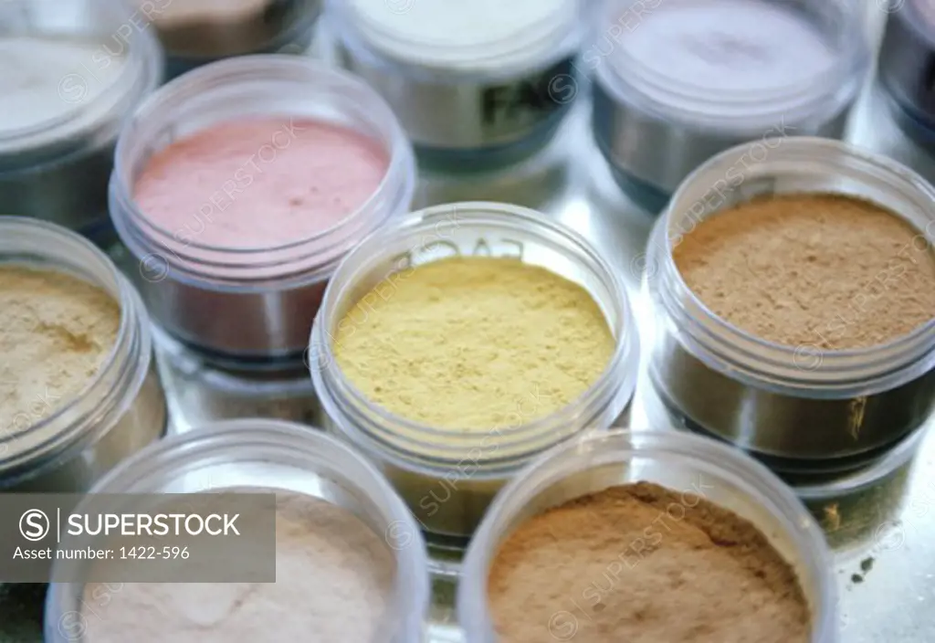 Close-up of open jars of make-up powder
