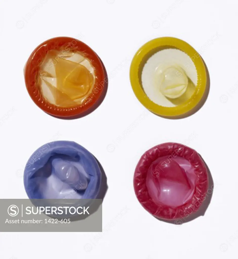 Close-up of four unwrapped condoms