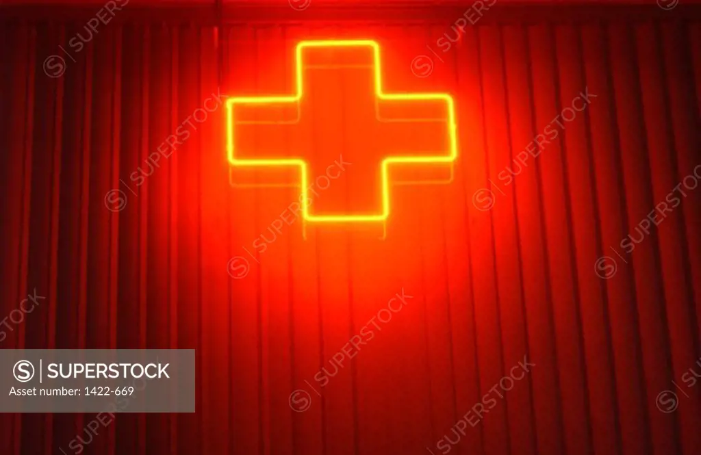 Low angle view of a neon cross sign
