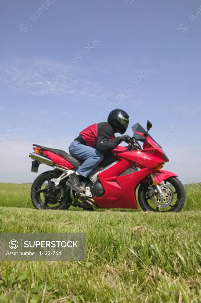 Side profile of a person riding a motorcycle