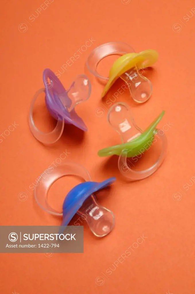 Close-up of four pacifiers