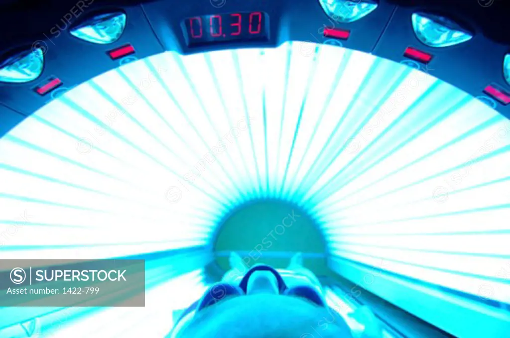 Low section view of a person lying in a tanning bed