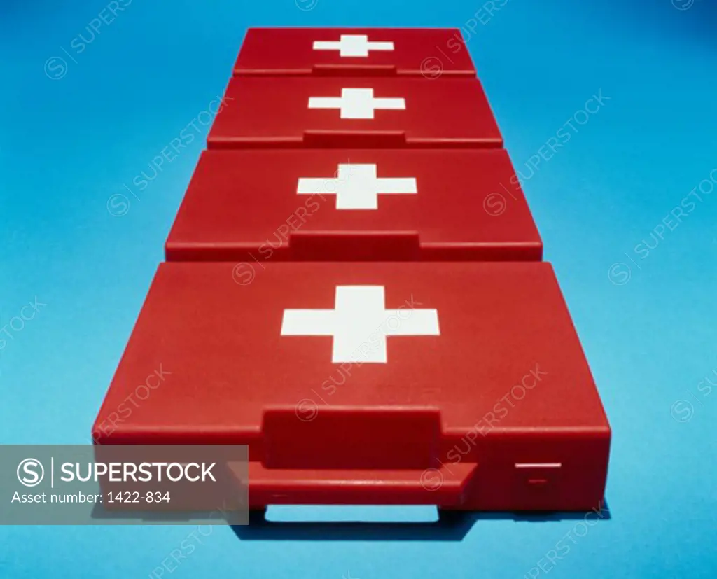 High angle view of four first aid kits