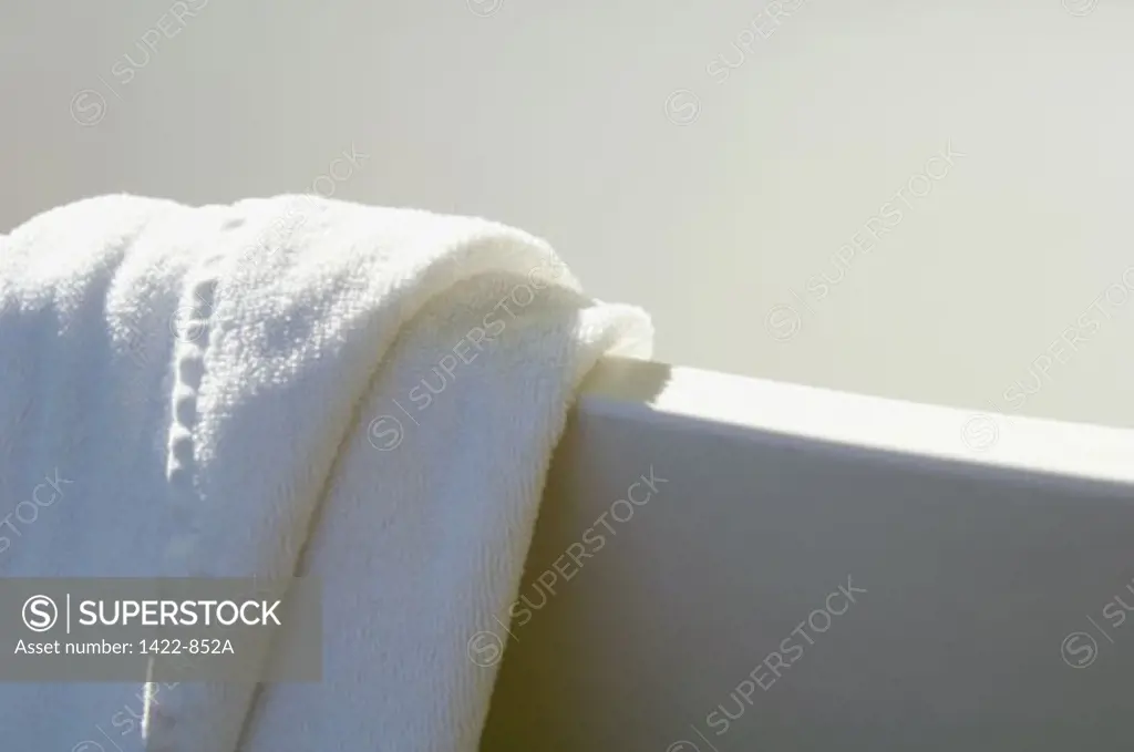 Close-up of a towel on the edge of a bathtub