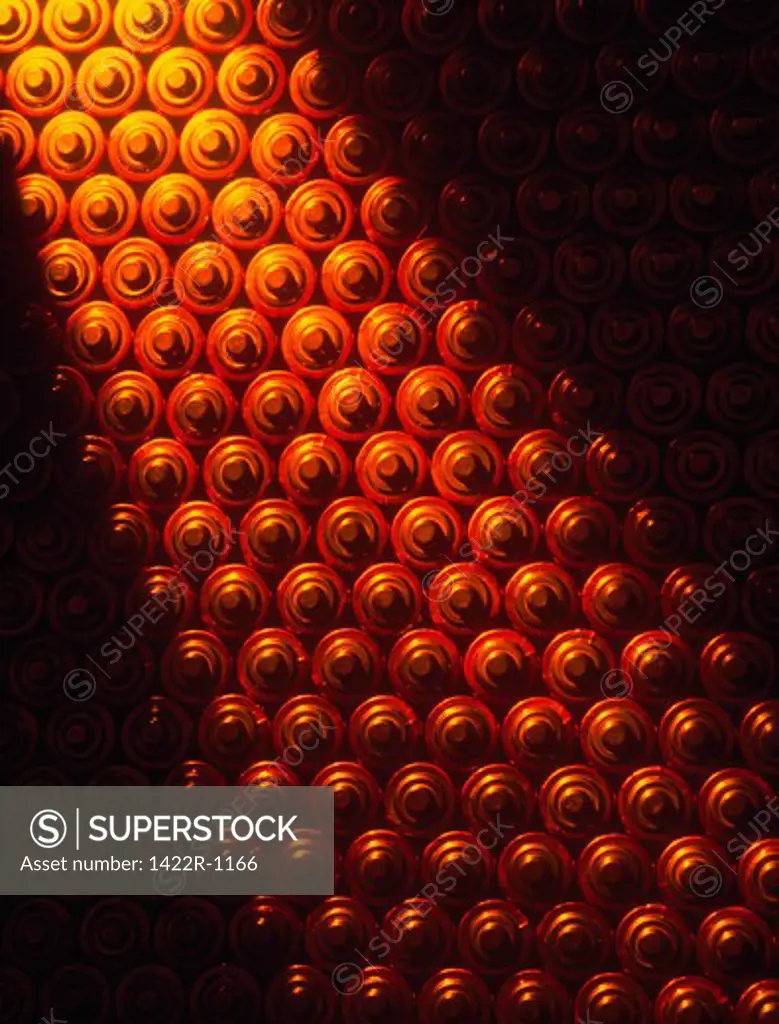 Warm light shining over a background of small consumer batteries