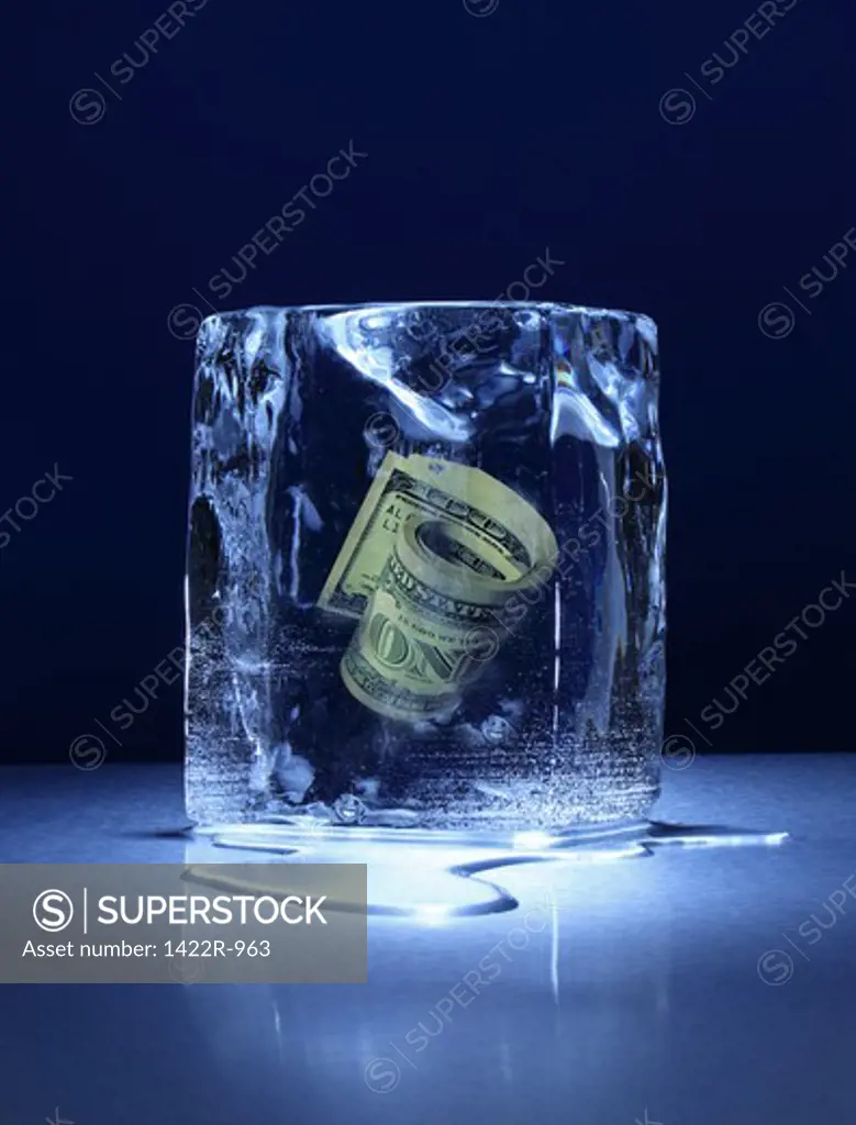 Large block of ice with roll of money frozen inside