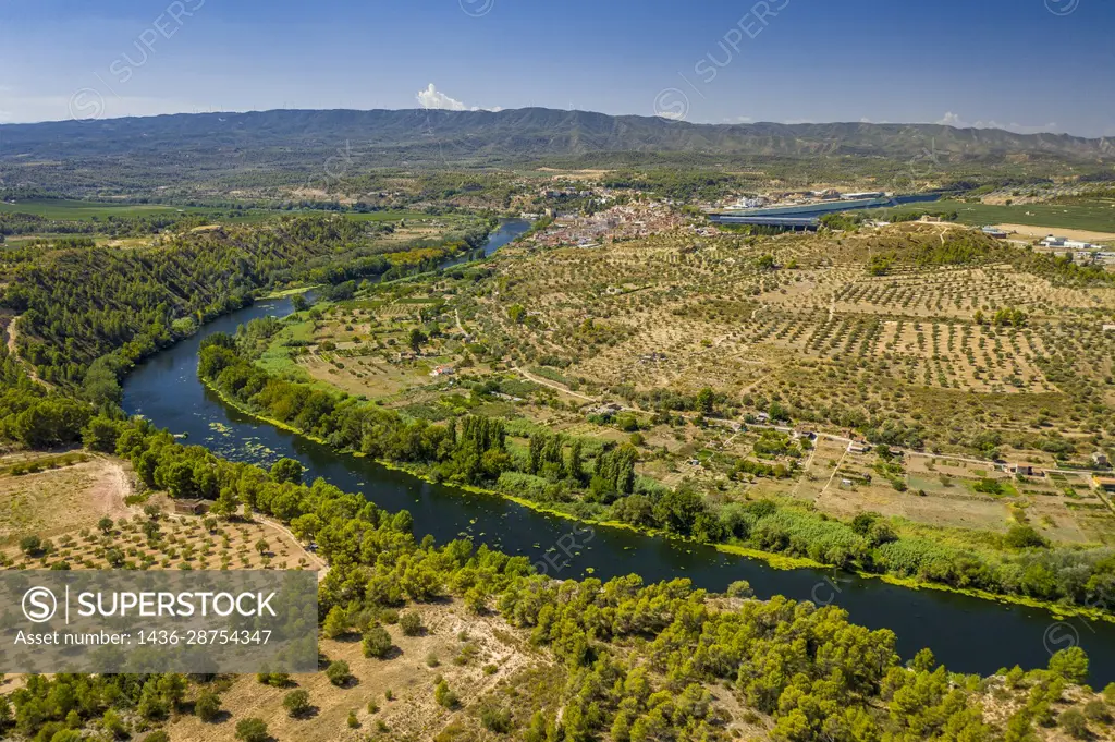 Aerial view of the Flix meander, where the Ebro river forms a huge meander around the castle and village of Flix (Ribera d'Ebre, Tarragona, Catalonia,...