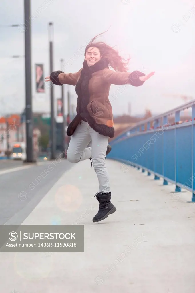 Woman dancing on walkway.