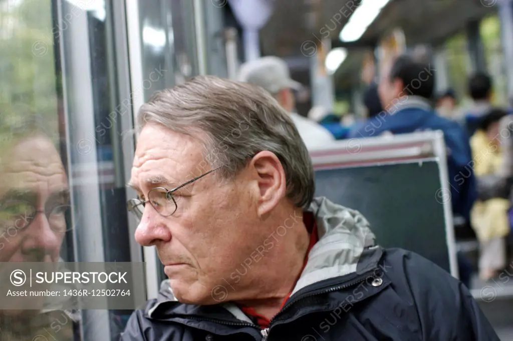 Senior man on a bus.