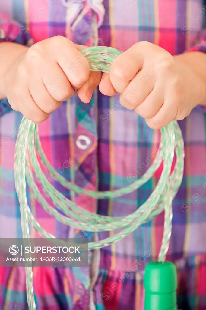 Close up of little girl (5 years) holding jump rope in her hands.