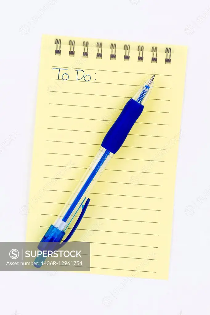 A sheet of lined yellow paper with To Do written on it and a blue pen.