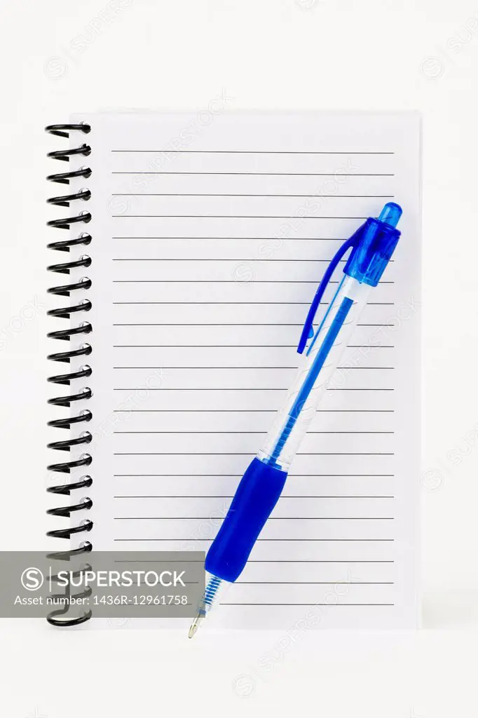 A white spiral notebook with lined pages and a blue pen.