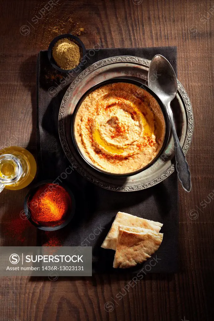 Hummus with paprika, cumin, olive oil and bread.