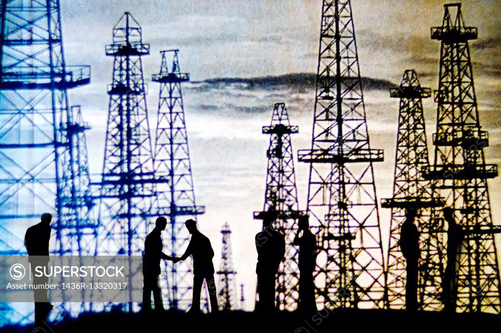 digital composition of unrecognizable people silhouettes, closing a deal with oil towers in the background.