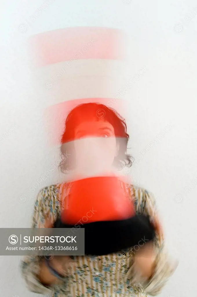 Young woman with a traffic cone moving in front of the face, with ability to hide.