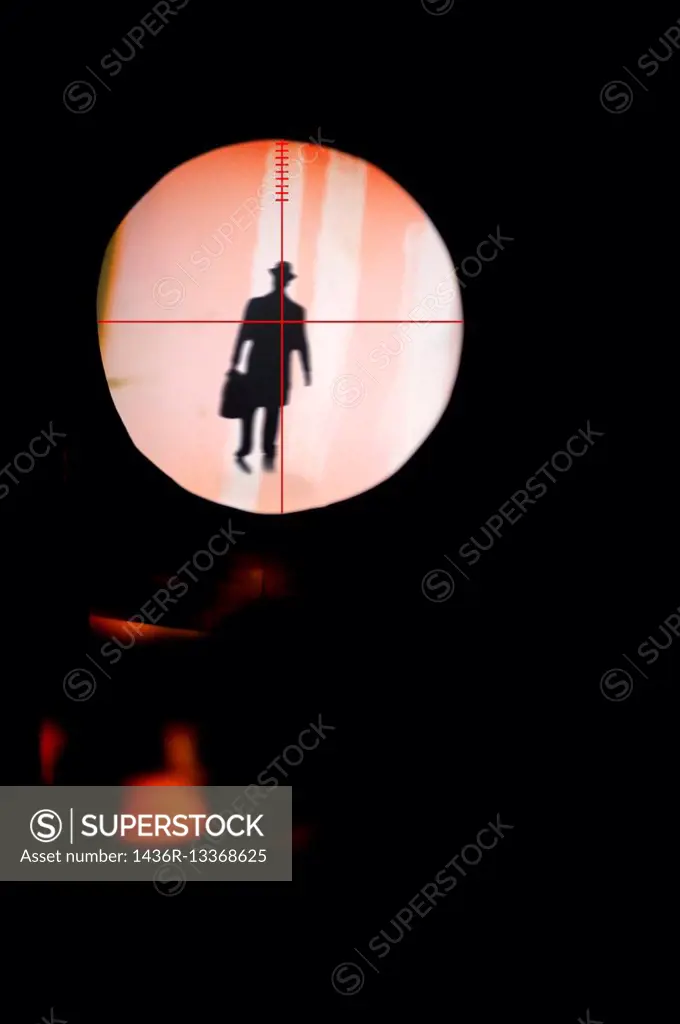 Silhouette of a unrecognizable man with a executive briefcase on a spotlight.