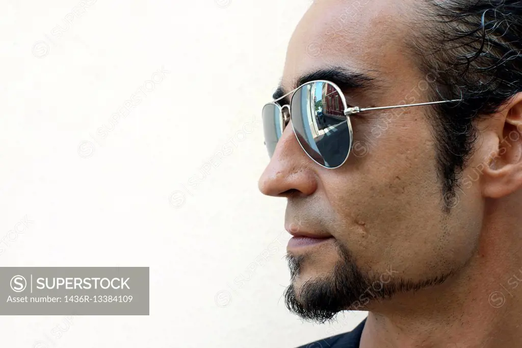 Profile of man with goatee and sunglasses.