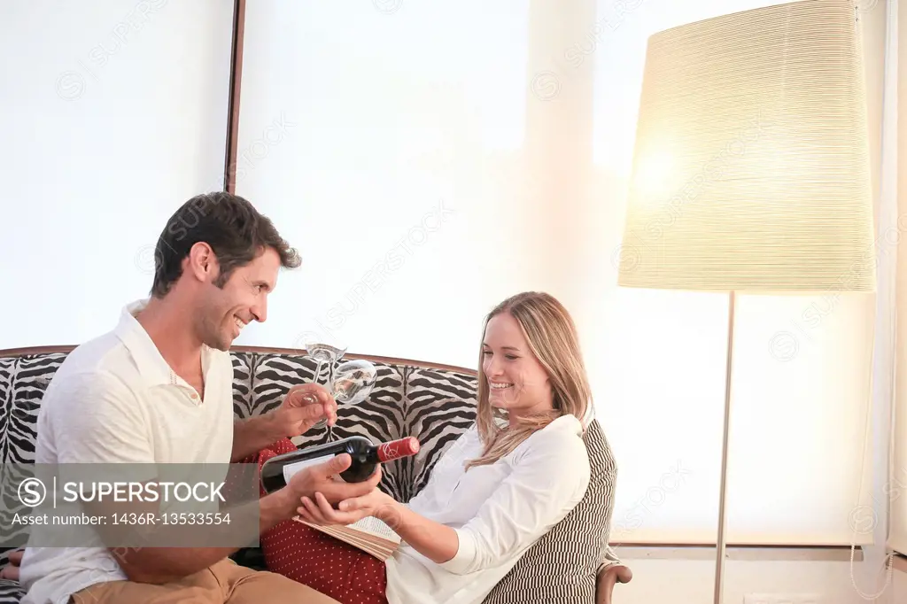 Couple with bottle of red wine