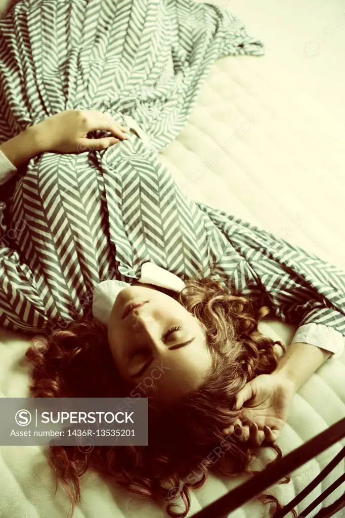 Young woman sleeping in bed.