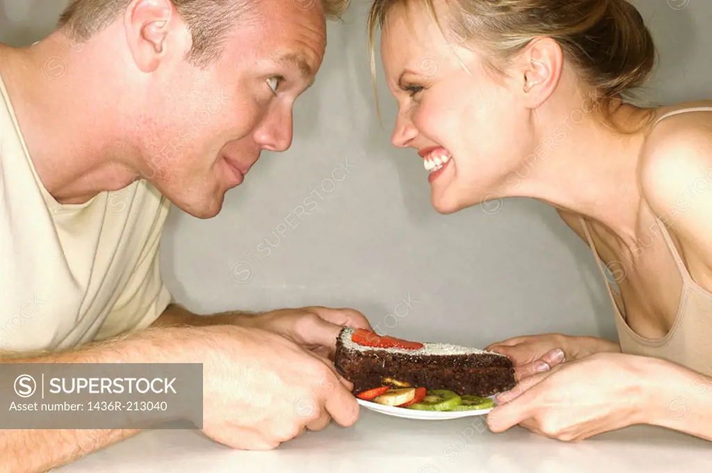 Couple fighting for a cake