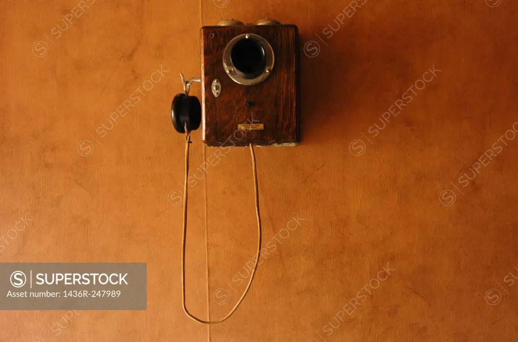 Old historic telephone on red wall. Silver City, Idaho. USA