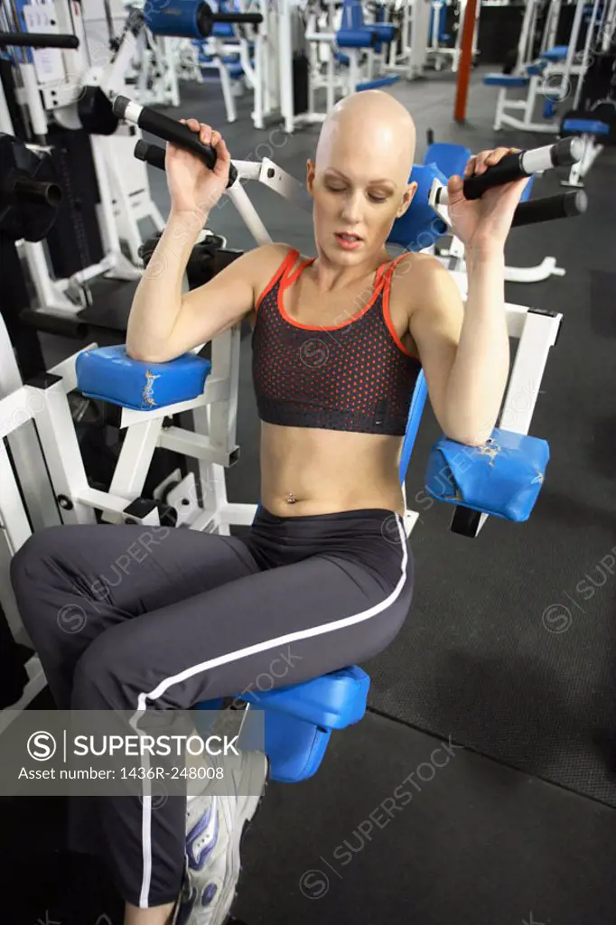 Caucasian woman with cancer/alopecia areata working out