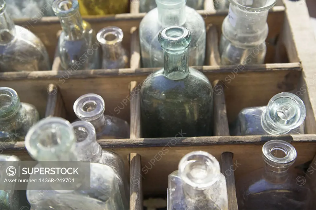 Antique bottles in wooden box