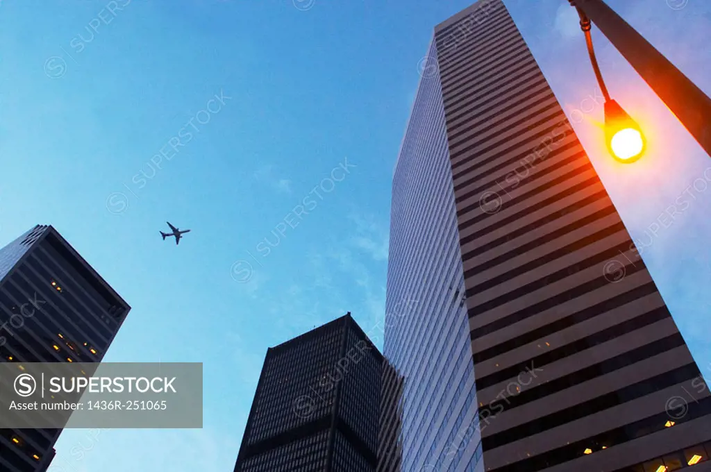Seattle, Washington State, USA - Plane flying above city's skyscrapers