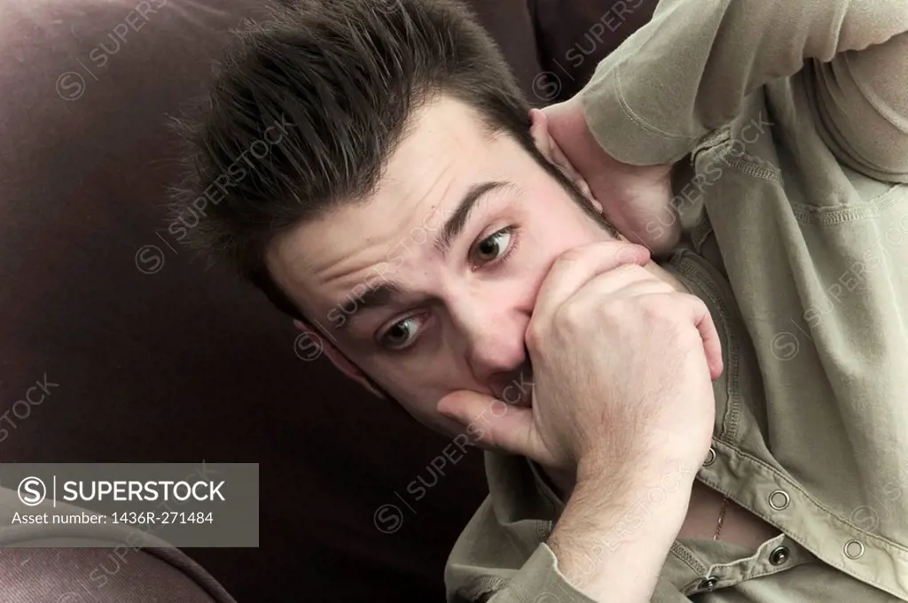 Close_up of a young man resting on a sofa