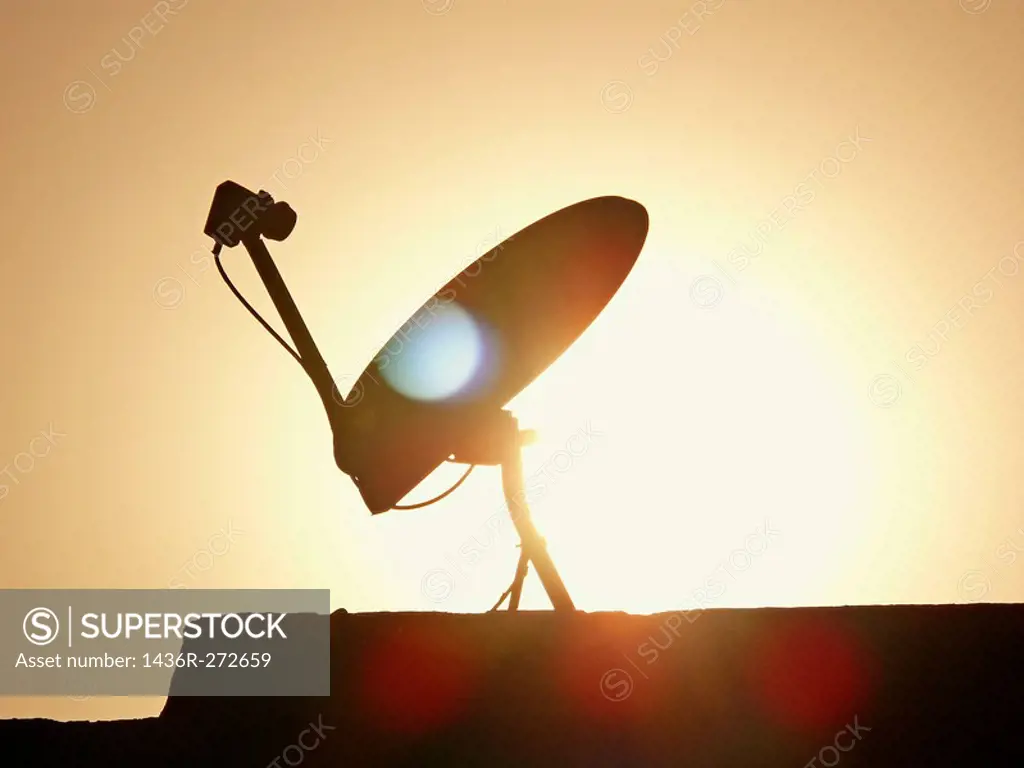 A dish antenna of a television set on a building terrace. Pune, Maharashtra, India.