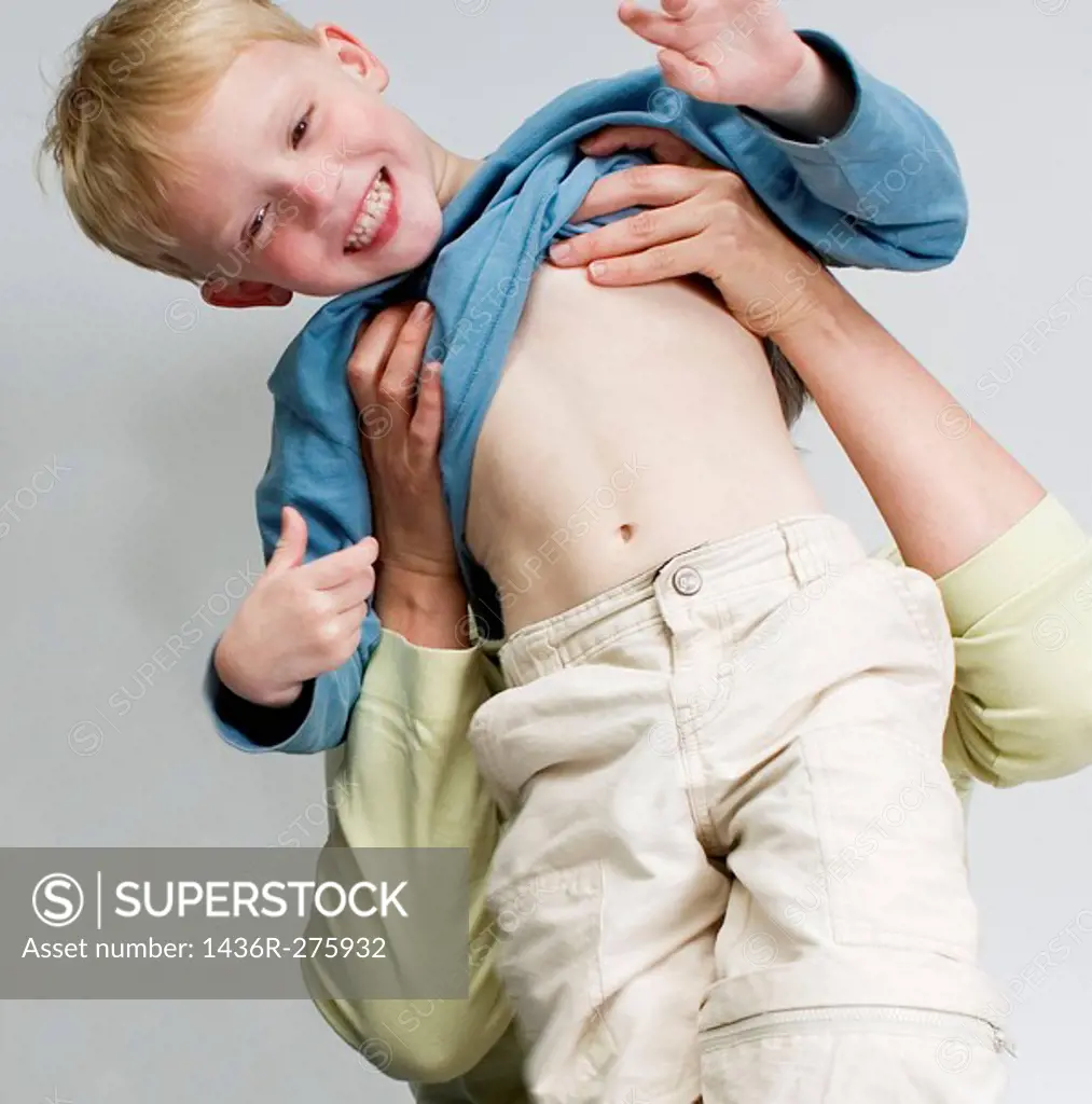 Four-year-old boy being lifted up by his mother