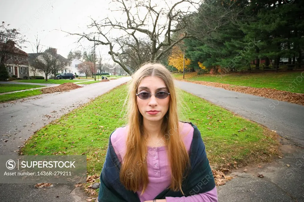 Young woman, wearing sunglasses, posing