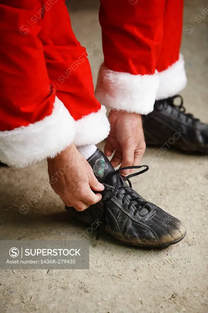 Santa putting on baseball shoes