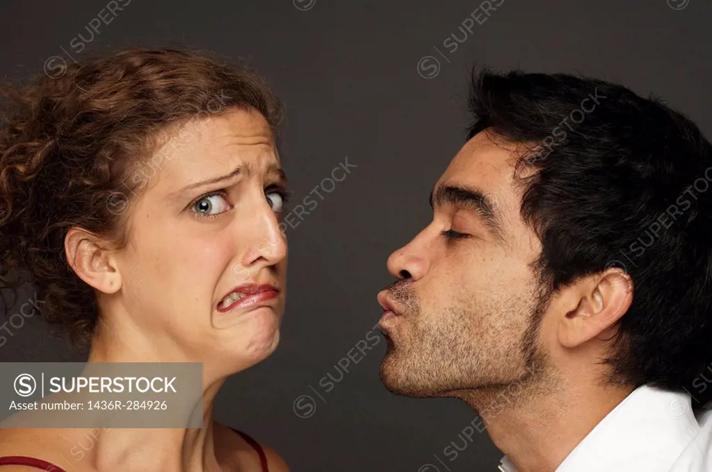 Man tries to kiss woman while she reacts affraid to it