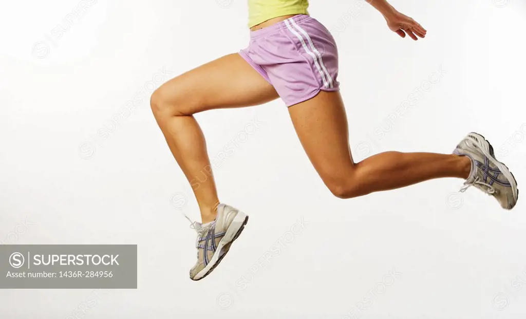 Woman running in a studio setting