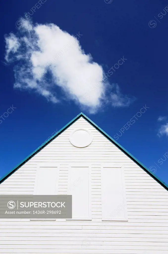 Cloud and wooden building with pitched roof