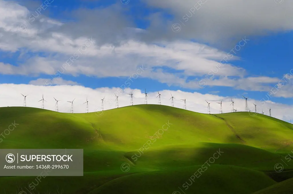 Winter sun on the rolling green hills of the Altamont Pass wind farm in California