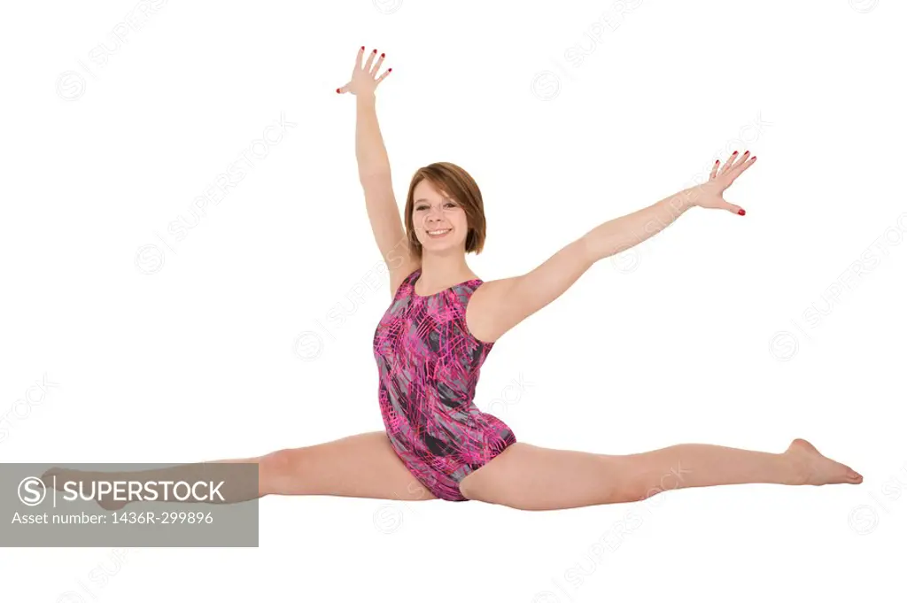 Caucasian teenage girl in gymnastic poses on white background